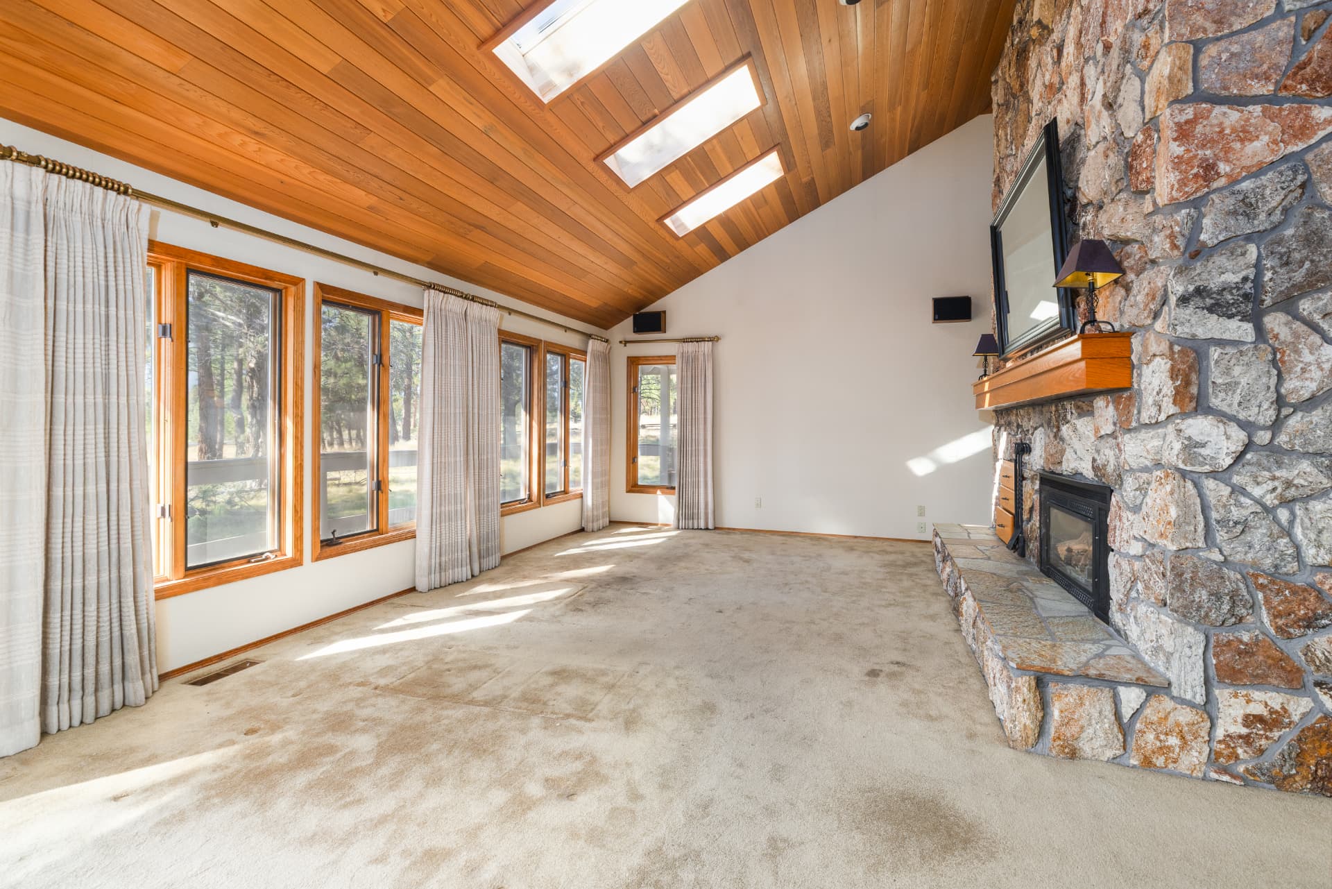 Vaulted living room with stone fireplace